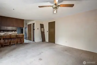 Family room looking towards kitchen to the left and door to the garage on the right.