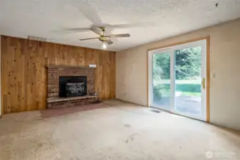 Family room with wood stove and slider to back deck.