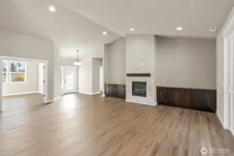 Living Room with Cozy Gas Fireplace Opens to Dining Room
