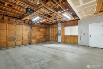 Large 2-car garage with tons of storage and built in ladder to access additional upper storage area