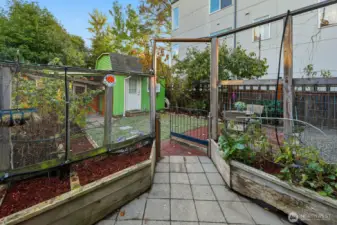 Relax in a generous backyard filled with blooming flowers and fruitful Italian plum trees.