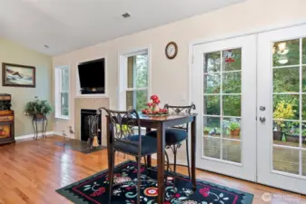 Dining Room with Oak Hardwood Floor and French Doors that Open to Private Deck