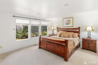 Spacious MAINFLOOR Primary bedroom has lots of natural light