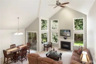 This picture says it all with the dining room, great room ready for entertaining or just enjoying as your personal enclave with mature landscape outside