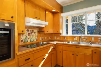 Older but high quality solid wood cabinets and hand painted tiles.