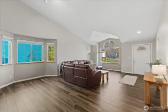 Spacious living room featuring soaring vaulted ceilings