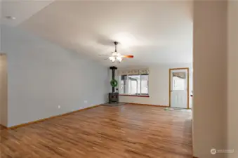 Main living area with vaulted ceilings and laminate floors.