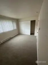 Bedroom with large window and roomy closet.