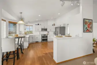 The refreshed white kitchen boasts sleek new quartz countertops.