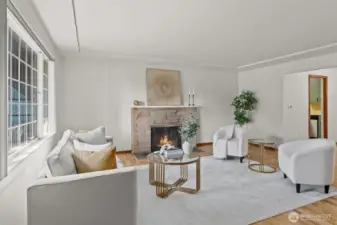 Relax by the fireplace in the living room with plenty of natural light.