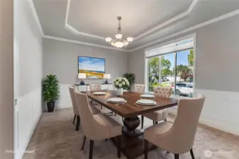 Elegant dining room with classic wainscoting and crisp white trim, enhanced by a large window that fills the space with natural light. A coved ceiling adds architectural charm, while convenient access to the butler’s pantry and kitchen makes entertaining a breeze.