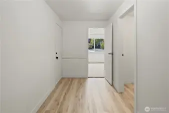 Mudroom off carport and main living area with seperate entry, leads to a 1/2 bath and an additional room with closet.