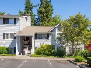 A view from the front of the condo illustrates the entrance to home sweet home. One of the two reserved parking spots in right in front of the unit.