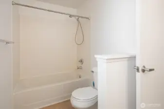 The primary bathroom is bright with new paint and new flooring.