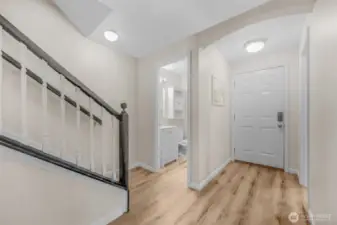 Stairs, main floor half bath and entry way