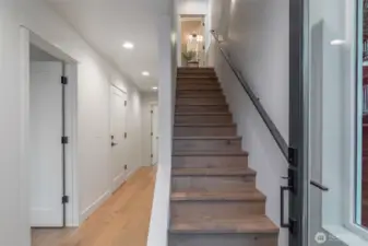 Photo is of unit 6510. Entryway + stairwell. Garage, bedroom, and a full size bathroom + closet make up the lower floor.