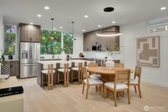 Wide open gourmet kitchen with ceiling height windows