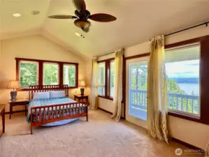 The spacious and bright second floor primary bedroom has access to its own balcony and views of Port Susan and the Cascade Mountains.