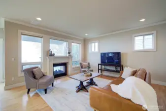 Unique see-through fireplace connects the living room to the back patio—perfect for indoor and outdoor enjoyment.