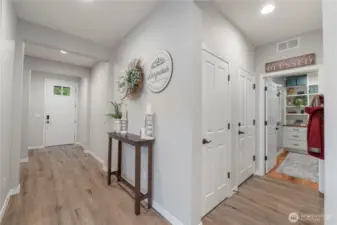 Beautiful entry presents even MORE upgrades and improvements. Window'ed door with a security peep hole, wood-wrap finishes and baseboards, seller-improved closets and that beautiful room to the right is a LAUNDRY ROOM customized for flair and function, both.