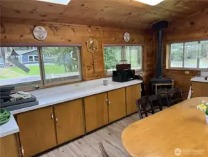 Tiny home kitchen/entertaining room offers plenty of cabinets for storage.