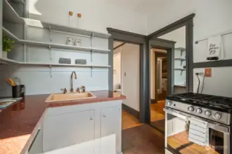 Cozy vintage kitchen with dishwasher and gas cooking.