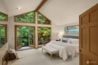 Light and bright primary bedroom suite on upper level completes with fireplace and balcony and views of the lake through the East facing window.