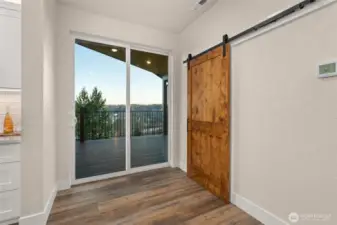 Sliding glass door out to covered deck & sliding door to butlers pantry.