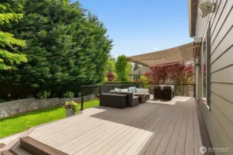 Rear yard with composite deck, gathering area with gas firepit, hot tub, gas BBQ, play area and garden space; everything for everyone!