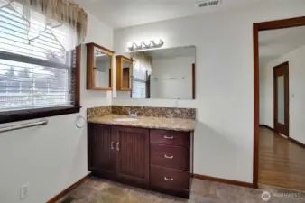 primary bath with step in shower off to the right of the photo