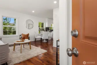 Just inside the covered porch is this formal entry that opens up to the living room with engineered wood floors.