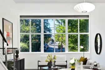 Incredible wall of windows let's the sun shine through this home's main level. Notice the green views looking west onto Lee St. The main level sits on the 2nd floor of the building for added privacy and peace. Welcome home.