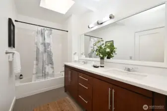 The upper full bath is clean and bright and offers a double vanity with lots of storage space, a full bathtub and a shower on the opposite end. The skylight is a nice addition and keeps with the light and brightness of this home.
