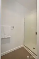 The primary bathroom offers a standalone 3/4 shower-nice separation from the tub!  The toilet area is just opposite the shower.
