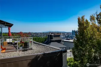 From this home's spectacular 400 sq ft view deck looking southeast to Capitol Hill, the Cascades and the city (the  deck pictured here belongs to the neighbor but is not nearly as close as it appears).