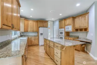 Large kitchen with granite counter tops.