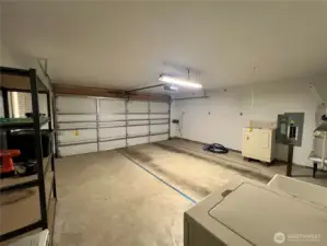 A finished garage, roomy with shelving