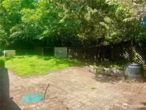 Back yard is private with firepit and gardening area