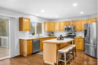 Island with breakfast far and slider to backyard with brand new backyard deck.