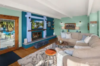 Deck & hot tub off the living room with wood burning fireplace