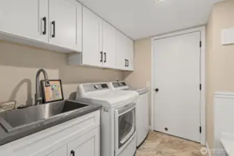 Remodeled and spacious laundry room with sink. W/D can stay with home.