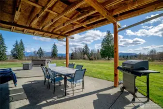 Large covered patio on ADU includes hot tub and outdoor shower