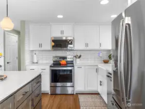 Gorgeous shaker cabinets and quartz counters. Under Island Storage and timeless classis white subway tile! All matching stainless steel appliances! The chef will absolutely adore the gourmet kitchen!