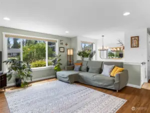 Natural light invites you in this inviting living room with territorial view of the landscaped front yard.