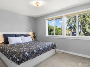 Primary bedroom boasts two large windows with lots of natural light and a territorial view of the park like backyard!