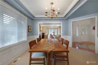 Beautiful dining room also with wainscoting and a coffered ceiling.