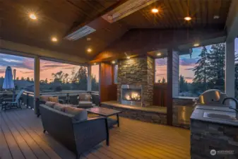 A beautiful and expansive wrap-around deck is an inviting retreat easily accessible through sliding glass doors. This well-appointed covered area complete with a cozy fireplace, overhead heaters, sink & built-in BBQ, is perfect for year-round enjoyment.