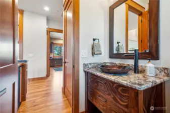 One of two elegant powder rooms located at the main floor. A beautiful custom vanity was created for this space.