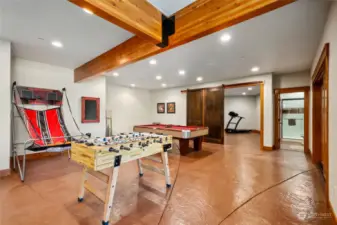 A haven for fun, this additional recreation space offers endless possibilities for enjoyment. Beyond the recreation room and through a sliding barn door, a large gym invites you to achieve your fitness goals.