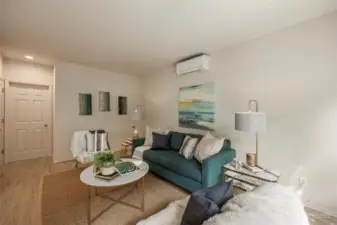 Additional sitting room/living space is just to the other side of the kitchen with windows for natural light.